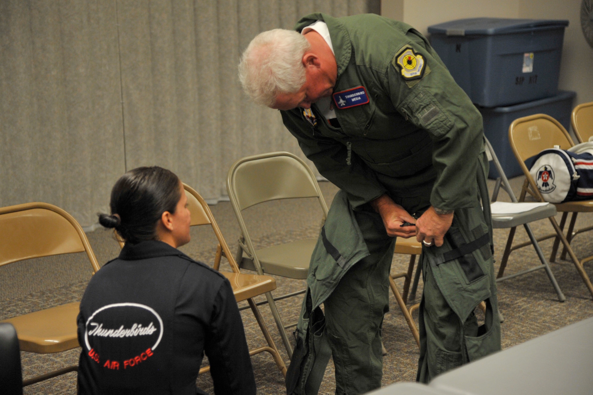 PETERSON AIR FORCE BASE, Colo. -- John Fox (right), Denver Broncos head football coach, is fitted for a G-suit by Tech. Sgt. Amber Alumpe, Thunderbirds crew, May 21 at Peterson AFB. The U.S Air Force Air Demonstration Squadron was at Peterson May 21-24 for the U.S. Air Force Academy graduation and selected Fox for an orientation flight. Fox received briefings and a flight physical, but the two-seat F-16 aircraft had mechanical difficulties and he was not able to fly. The Thunderbirds, however, offered to give him a flight at a later date. (U.S. Air Force photo/Robb Lingley)