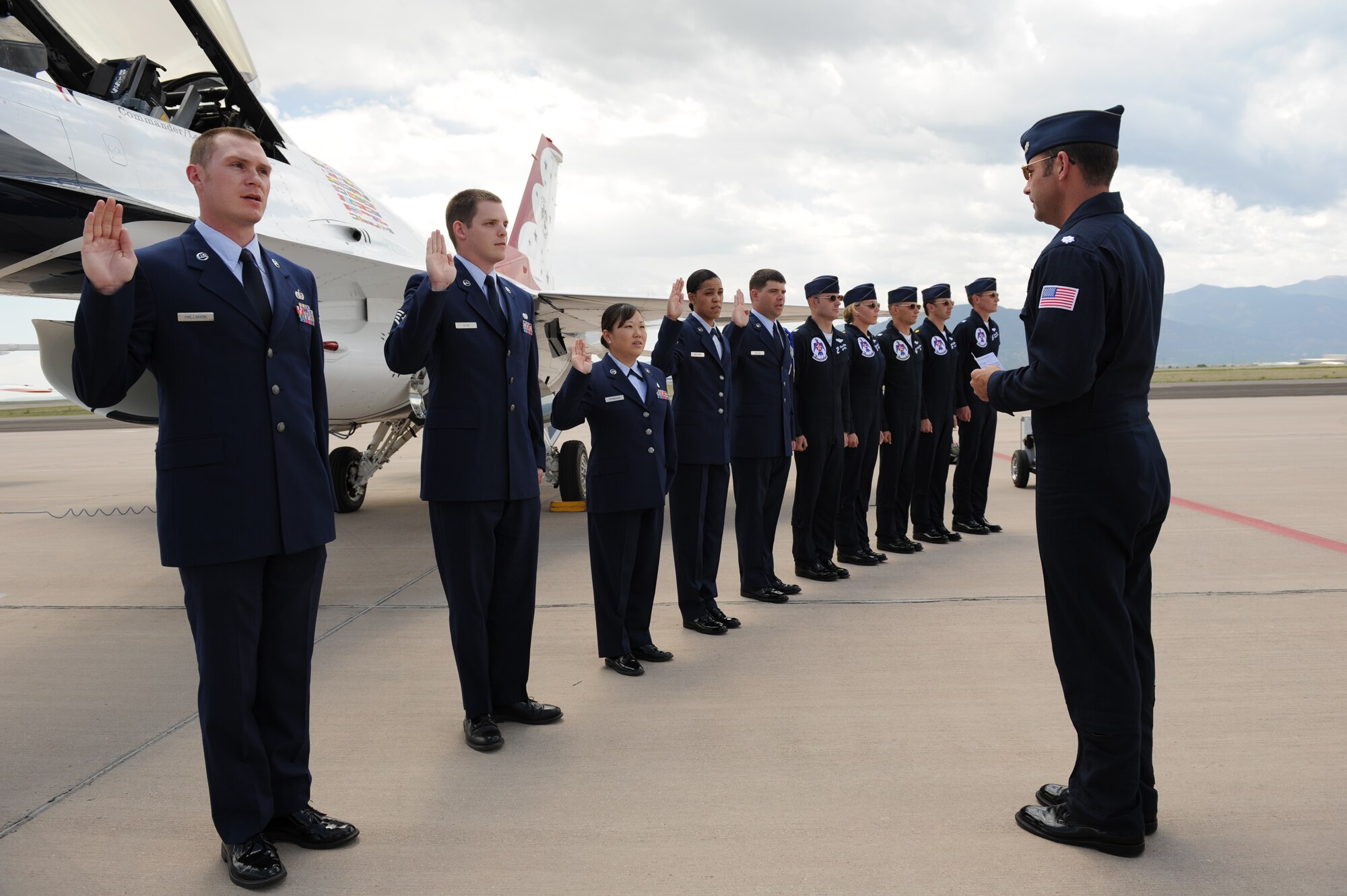 PETERSON AIR FORCE BASE, Colo. -- Lt. Col. Greg Moseley, U.S. Air Force Air Demonstration Squadron commander and Thunderbirds pilot, administers the oath of re-enlistment May 21 on the Peterson flight line. The Thunderbirds were in town for the U.S. Air Force Academy graduation May 23 and hosted the unique re-enlistment ceremony while at Peterson. (U.S. Air Force photo/Staff Sgt. Larry Reid)