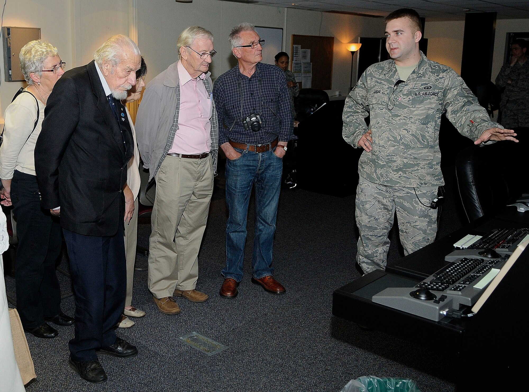 ROYAL AIR FORCE LAKENHEATH, England - Staff Sgt. Robert Legg (right), 48th Operations Support Squadron air traffic control journeyman, briefs Kenneth Wallis, retired RAF wing commander (left) and the RAF Halton Ex Apprentices group about radar displays in the Radar Approach and Control office May 24, 2012.  Wallis, age 96, served as a pilot during WWII and holds world records for flying autogyros, an aircraft that is a cross between a helicopter and a glider. (U.S. Air Force photo by Staff Sgt. Connor Estes)