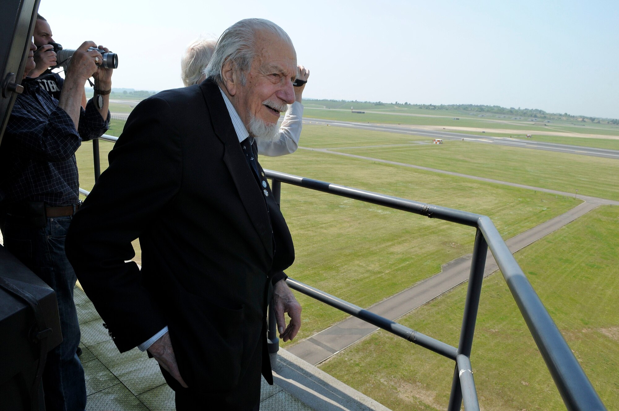 ROYAL AIR FORCE LAKENHEATH, England - Kenneth Wallis, retired RAF wing commander, watches aircraft take off from the air traffic control tower during a tour of the base May 24, 2012.  Wallis, age 96, served as a pilot during WWII and holds world records for flying autogyros, an aircraft that is a cross between a helicopter and a glider. (U.S. Air Force photo by Staff Sgt. Connor Estes)