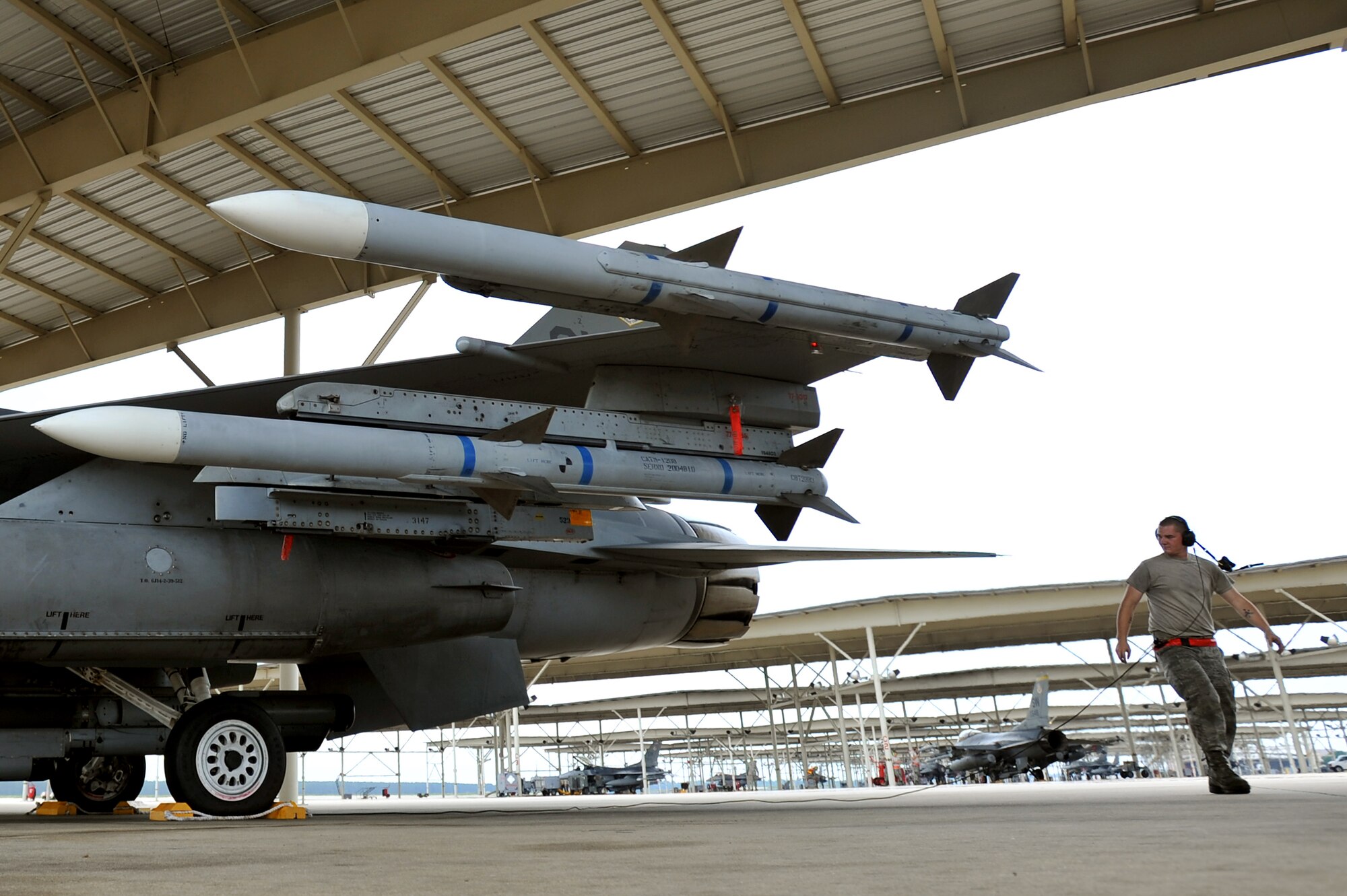 U.S. Air Force Airman 1st Class Chris Weber, 20th Aircraft Maintenance Squadron crew chief, does his last minute checks on an F-16 Fighting Falcon before launching the aircraft during an Operational Readiness Exercise, May 22, 2012, Shaw Air Force Base, S.C. Several of Shaw's F-16 pilots participated in an elephant walk during the ORE. An elephant walk occurs when aircraft taxies down the runway in large numbers, which represents the ability to generate a large number of aircraft needing to take off rapidly for a military response. (U.S. Air Force photo by Senior Airman Kenny Holston/Released)


