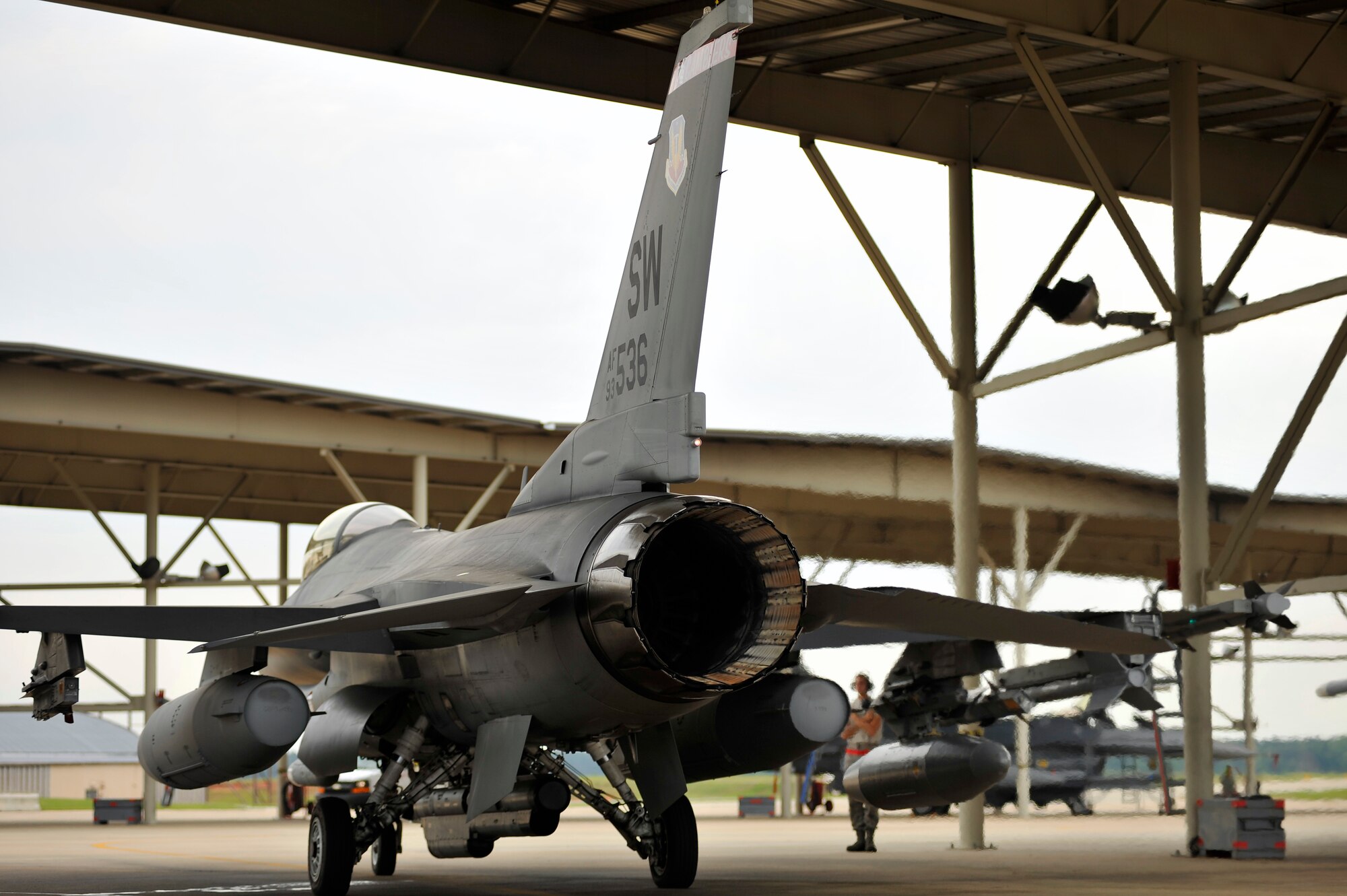 A U.S. Air Force F-16 Fighting Falcon assigned to Shaw Air Force Base, S.C., is marshaled from its parking spot to participate in an elephant walk during an Operational Readiness Exercise, May 22, 2012, Shaw AFB, S.C. An elephant walk occurs when aircraft taxies down the runway in large numbers, which represents the ability to generate a large number of aircraft needing to take off rapidly for a military response. (U.S. Air Force photo by Senior Airman Kenny Holston/Released)


