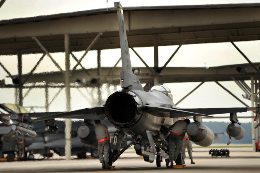 U.S. Air Force crew chiefs assigned to the 20th Aircraft Maintenance Squadron, preps an F-16 Fighting Falcon prior to launching it for an elephant walk during an Operational Readiness Exercise, May 22, 2012, Shaw Air Force Base, S.C. An elephant walk occurs when aircraft taxies down the runway in large numbers, which represents the ability to generate a large number of aircraft needing to take off rapidly for a military response. (U.S. Air Force photo by Senior Airman Kenny Holston/Released)