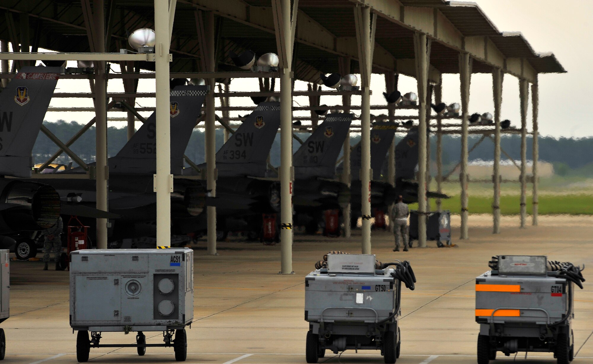 Several U.S. Air Force F-16 Fighting Falcons assigned to Shaw Air Force Base,S.C., are inspected by 20th Aircraft Maintenance Squadron crew chiefs before being launched to perform an elephant walk during an Operational Readiness Exercise, May 22, 2012, Shaw AFB, S.C.  An elephant walk occurs when aircraft taxies down the runway in large numbers, which represents the ability to generate a large number of aircraft needing to take off rapidly for a military response. (U.S. Air Force photo by Senior Airman Kenny Holston/Released)


