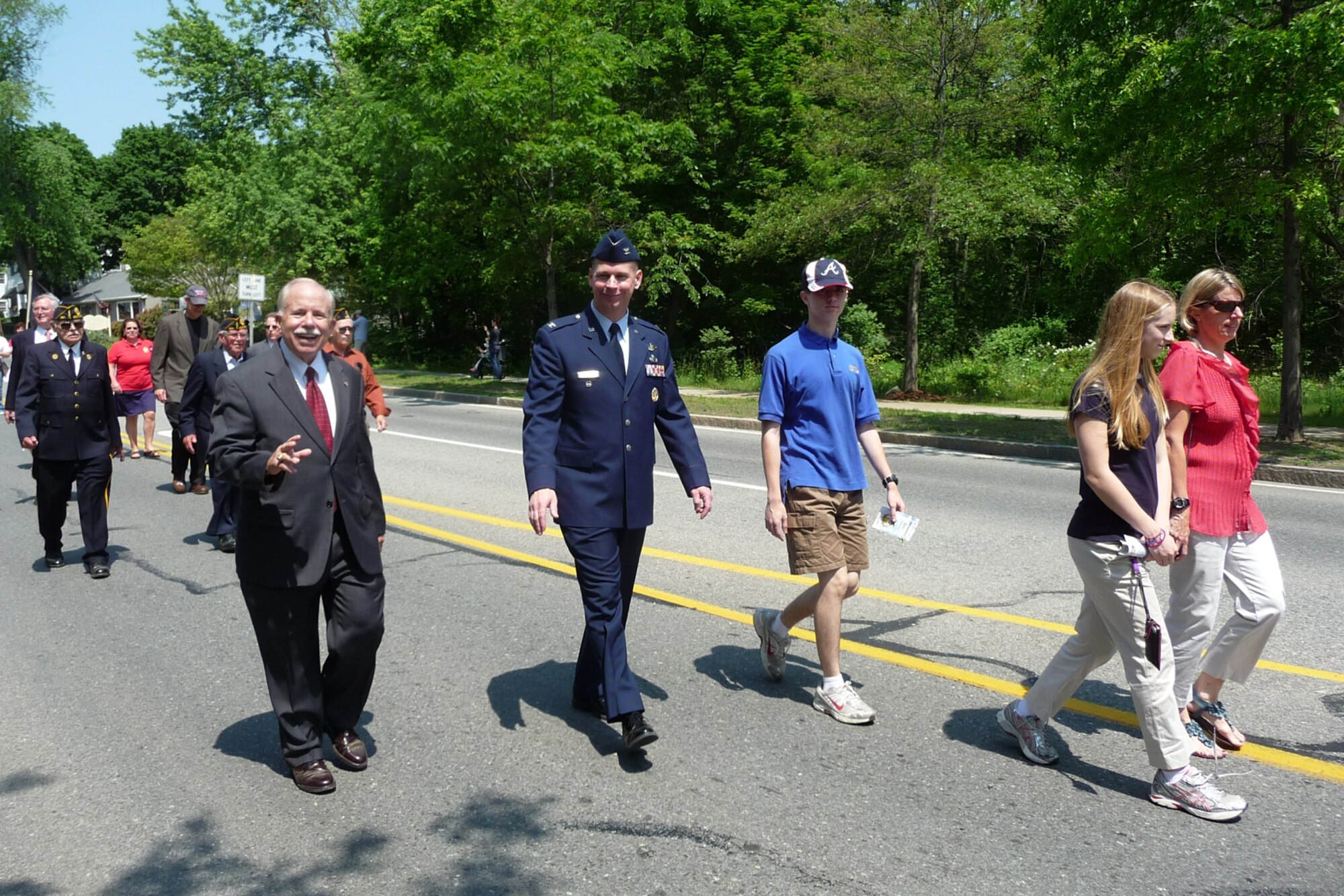 BEDFORD, Mass. -- Col. David Hiltz, Aerial Ground Surveillance Division senior materiel leader, marches in the Bedford annual Memorial Day parade May 28 with Paul Purchia, Patriotic Holiday Committee chairman (left) and Hiltz family members, (left to right) Garrett, Kendall and Barb. Hiltz delivered a Memorial Day message of “Giving Thanks to Veterans”. (Courtesy photo)