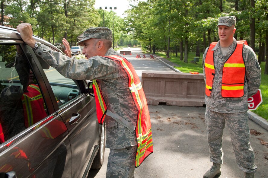 HANSCOM AIR FORCE BASE, Mass. -- Col. Lester A. Weilacher, 66th Air Base Group commander, and Chief Master Sgt. Baird Stiefel, remind drivers May 24 to wear safety belts and use hands-free cell phone devices while operating vehicles on base. Members of the safety office participated with base senior leaders during the check that was in coordination with the long holiday weekend. (U.S. Air Force photo by Mark Wyatt)