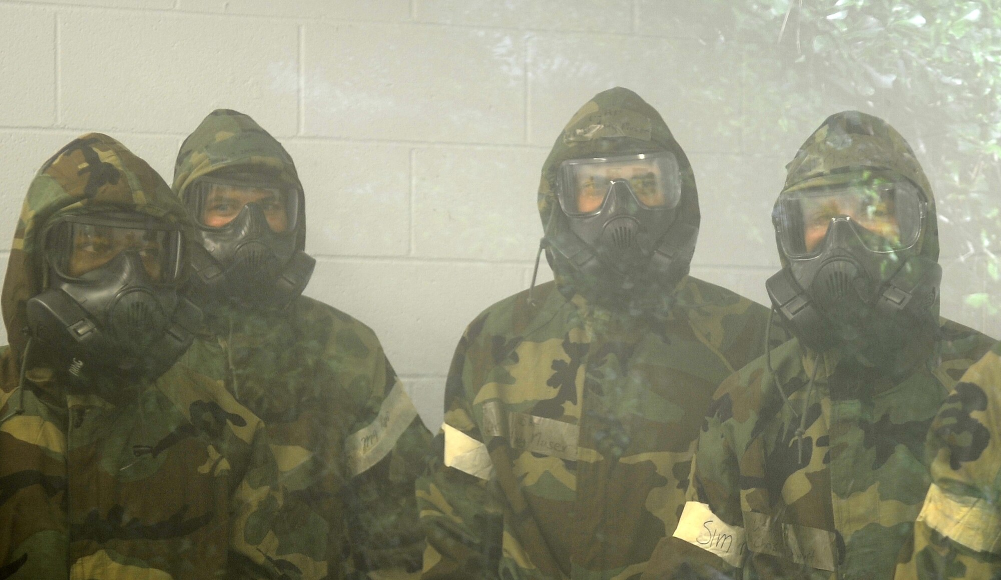 U.S. Air Force Airmen from the 4th Fighter Wing stand in a chamber filled with tear gas on Seymour Johnson Air Force Base, N.C., May 24, 2012. The Airmen removed their masks while in the chamber to feel the effects of a chemical agent and become more confident in how their protective equipment works. (U.S. Air Force photo/Senior Airman Gino Reyes/Released)
