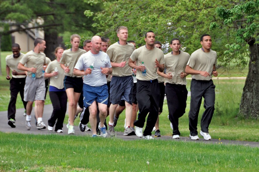 Tech. Sgt. Timothy Mullin (blue running shorts) leads Airmen during the development and training flight’s physical training session May 6. The purpose of the flight is to help prepare newly enlisted Airmen for basic training. (U.S. Air Force photo by Tech. Sgt. Jonathan White)