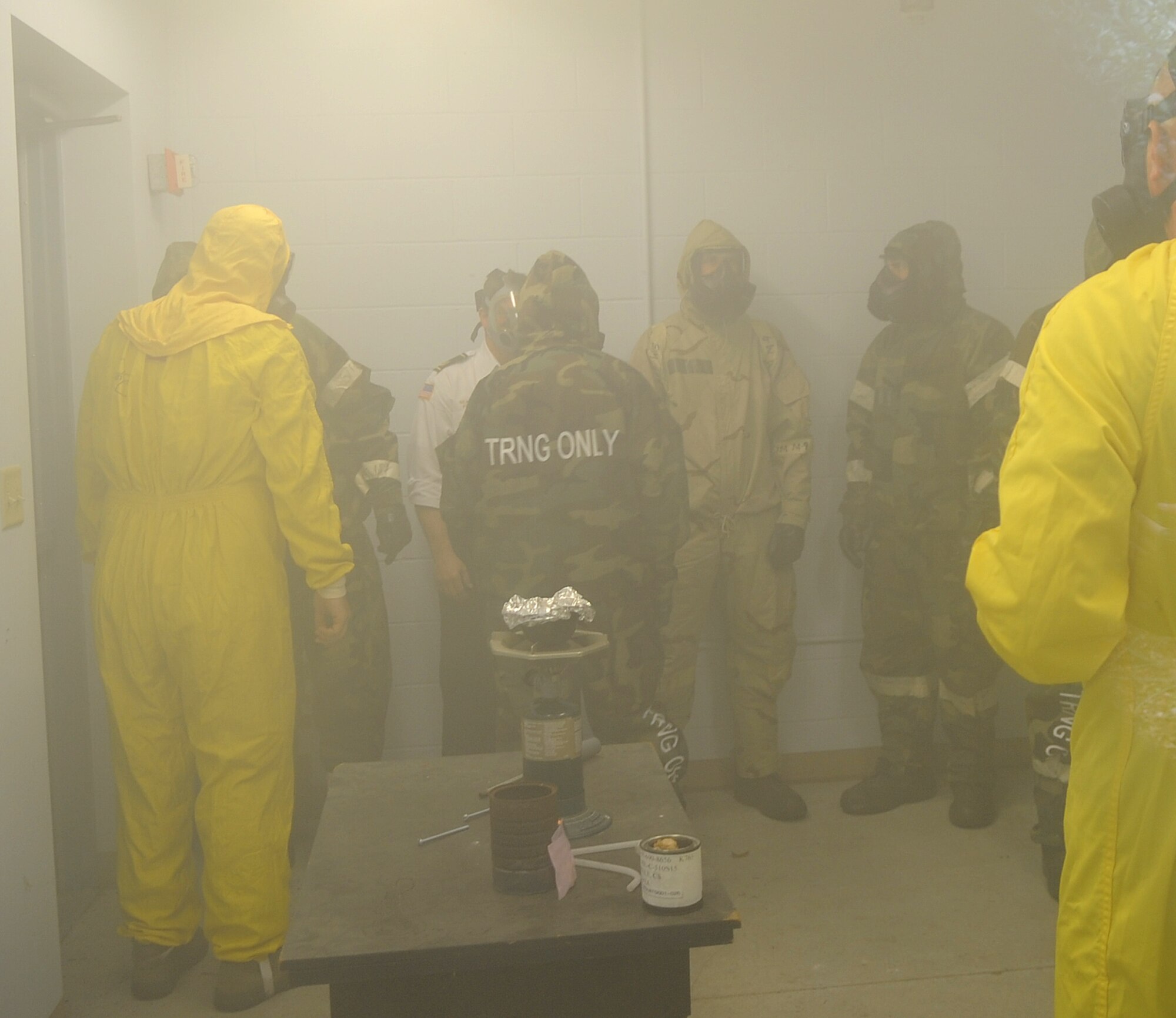 U.S. Air Force Airmen from the 4th Fighter Wing stand in a chamber filled with tear gas on Seymour Johnson Air Force Base, N.C., May 24, 2012. The Airmen participated in chemical biological radiological nuclear explosive training to learn how to prepare for chemical attacks. (U.S. Air Force photo/Senior Airman Gino Reyes/Released)