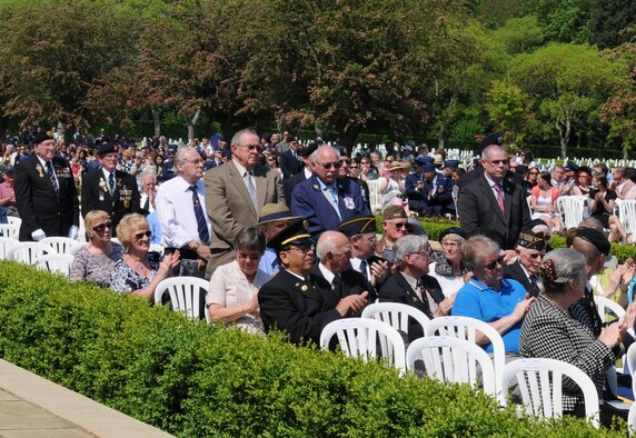 MADINGLEY, England – World War II veterans and family members of World War II veterans stand to be recognized for their service during the 68th Annual Memorial Day Observance May 28, 2012, at Cambridge American Cemetery. The cemetery contains more than 3,000 Service members who made the ultimate sacrifice. (U.S. Air Force photo/Senior Airman Rachel Waller) 