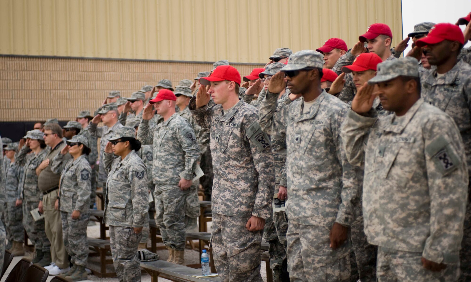U.S. Soldiers and Airmen deployed to Southwest Asia salute during the Memorial Day remembrance ceremony at memorial plaza, May28, 2012. More than 150 people attended the ceremony, which honored those who died while serving the U.S. military. (U.S. Air Force photo/Staff Sgt. Sheila deVera)