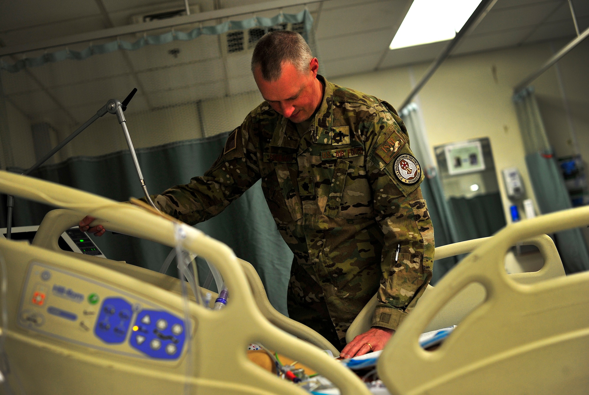 Air Force Chaplain (Lt. Col.) Brian Bohlman, 455th Air Expeditionary Wing, , meets with and prays with a severely injured Afghan girl at the Craig Joint Theater Hospital, Bagram Airfield, Afghanistan May 26, 2012. Chaplain Bohlman works the night shift at the hospital and routinely visits patients, American and Afghan, throughout the night helping them to cope with their circumstances. The hospital here employs 528 joint medical staff.(U.S. Air Force photo/Staff Sgt. Clay Lancaster)