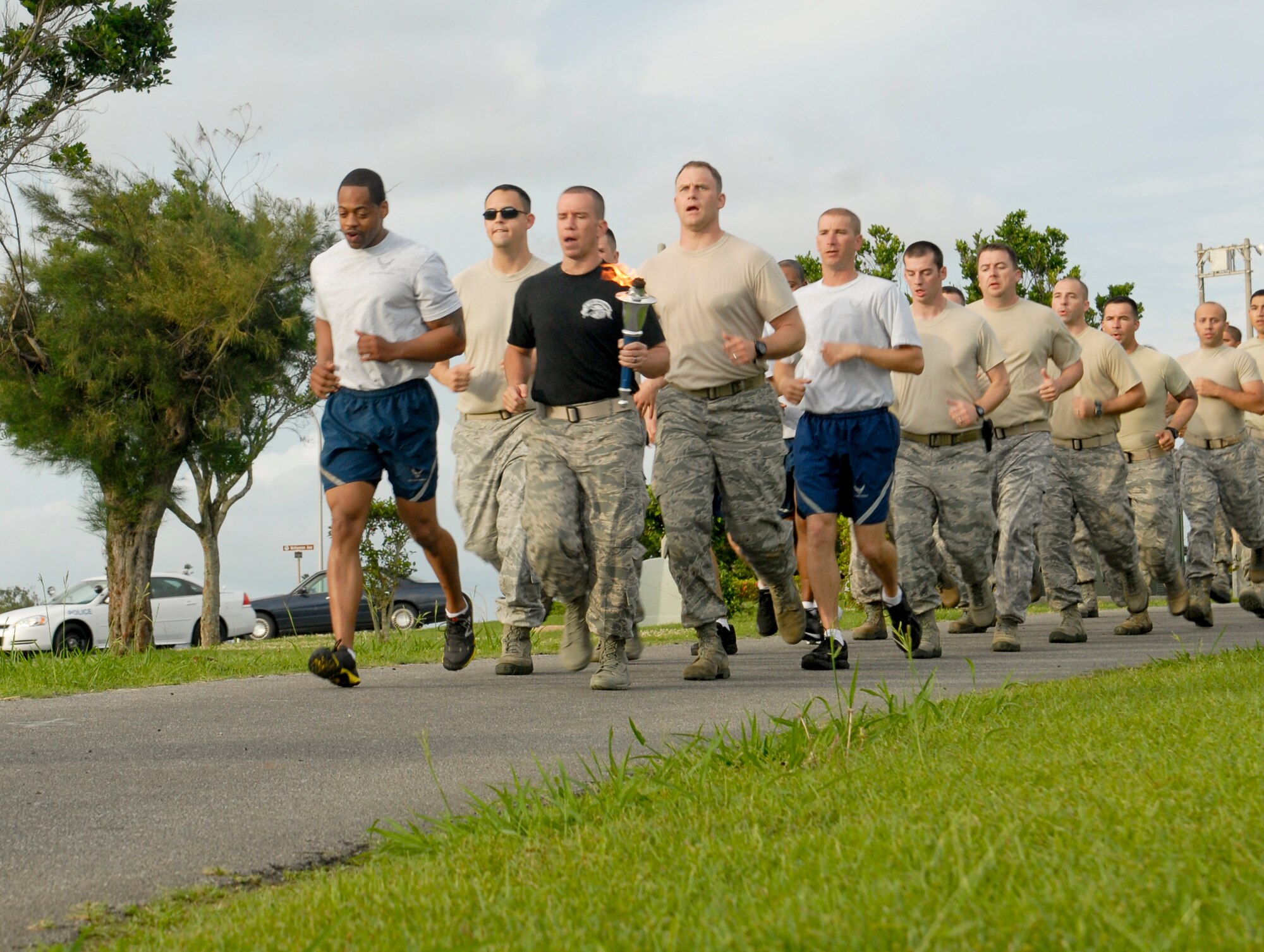 Members from all military branches run in a formation to start off a torch run at Marek Park honoring National Police Week on Kadena Air Base, Japan, May 23, 2012. Each hour of the run paid tribute to Airmen in security forces and Office of Special Investigations units Air Force-wide killed in the line of duty. (U.S. Air Force photo/Airman 1st Class Malia Jenkins)  
