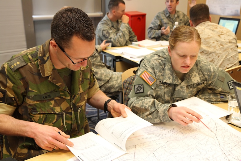 WIESBADEN, Germany — Netherland Capt. Leon Kaim, Center of Expertise Military Engineering, and U.S. Army 1st Lt. Samantha Turner, 243rd Engineer Detachment, work together during the U.S. Army Corps of Engineering Base Camp Development Planning Course held in Wiesbaden, Germany May 15 -18.
