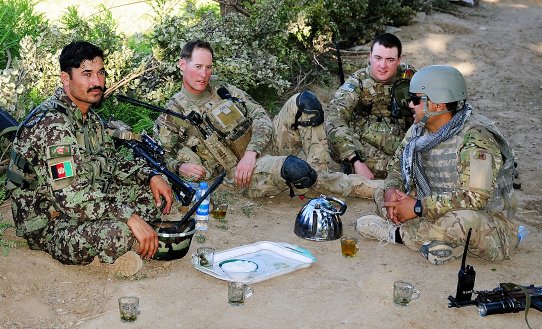 U.S. Army 1st Lt. Jake Jones and U.S. Army 1st Lt. Frank Worsham have tea with some Afghan soldiers and villagers in the Tani district in Afghanistan's Khost province, May 28, 2012. Jones, a platoon leader, and Worsham, a support officer, are assigned to the 1st Battalion, 501st Infantry Regiment, 4th Brigade Combat Team, 25th Infantry Brigade.