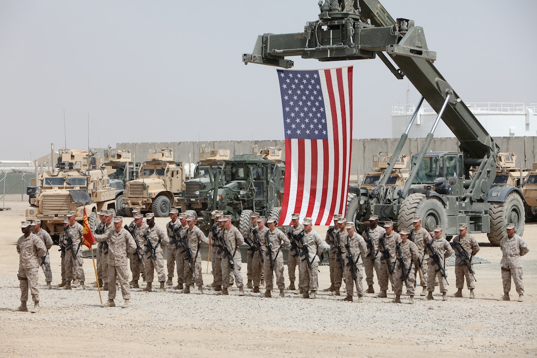 Marines and sailors from 9th Engineer Support Battalion stand in formation during a transfer of authority ceremony aboard Camp Leatherneck, Afghanistan, May 30. During the ceremony, 9th ESB transferred all general engineering responsibilities in support of 1st Marine Logistics Group (Forward) to 8th ESB.