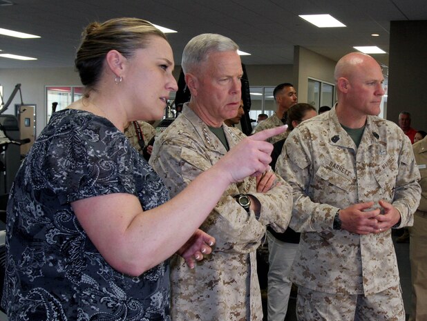 (From Left to Right) Melissa Mahoney, Sports Medicine and Injury Prevention coordinator, Gen. James F. Amos, Commandant of the Marine Corps, Sgt. Maj. Michael P. Barrett, Sergeant Major of the Marine Corps, and Brig. Gen. Daniel D. Yoo, commanding general, Marine Corps Recruit Depot San Diego and Western Recruiting Region, discuss the rehabilitation of injured recruits at the newly dedicated Walker Hall May 22 aboard Marine Corps Recruit Depot San Diego. Walker Hall is an energy-effcient, sports-medicine facility devoted to the rehabilitation of injured Marines and recruits. "This is a fantastic building," said Amos as he toured the facility. Walker Hall has been given the rating of platnium, the hightest rating of Leadership in Engery and Environmental Design according to U.S. Green Building Council standards. Amos and Barrett visited various Marine Corps installations during the Commandant's "Heritage Tour" and came to MCRD to offer leadership, guidence and motivation to officers and staff noncommisioned officers.