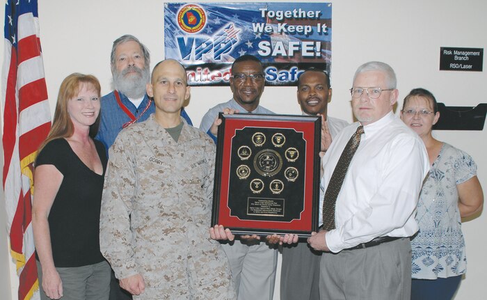 Brig. Gen. Thomas A. Gorry, commanding general, Marine Corps Installations East, Camp Lejeune, N.C., presents Marine Corps Logistics Base Albany’s Risk Management staff with the MCIEAST fiscal year 2011 Ground Safety Excellence Award May 24. This is the second year MCLB Albany has received the award.
