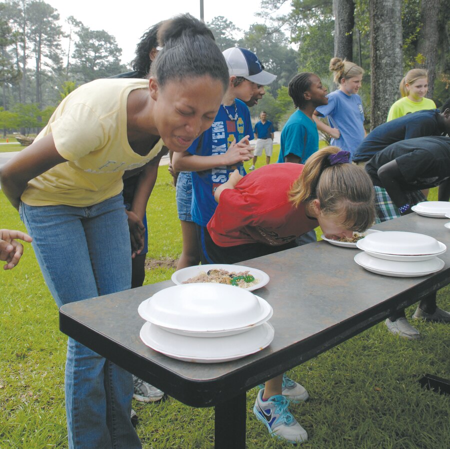 The last two contestants of the "Fear Factor" event struggle for first place while scarfing down less-than-desirable food. Event coordinators awarded the winner with a $30 gift certificate to the Marine Corps Exchange. Samantha Pappas was the winner and described the food as tasting like "stale pulled pork."