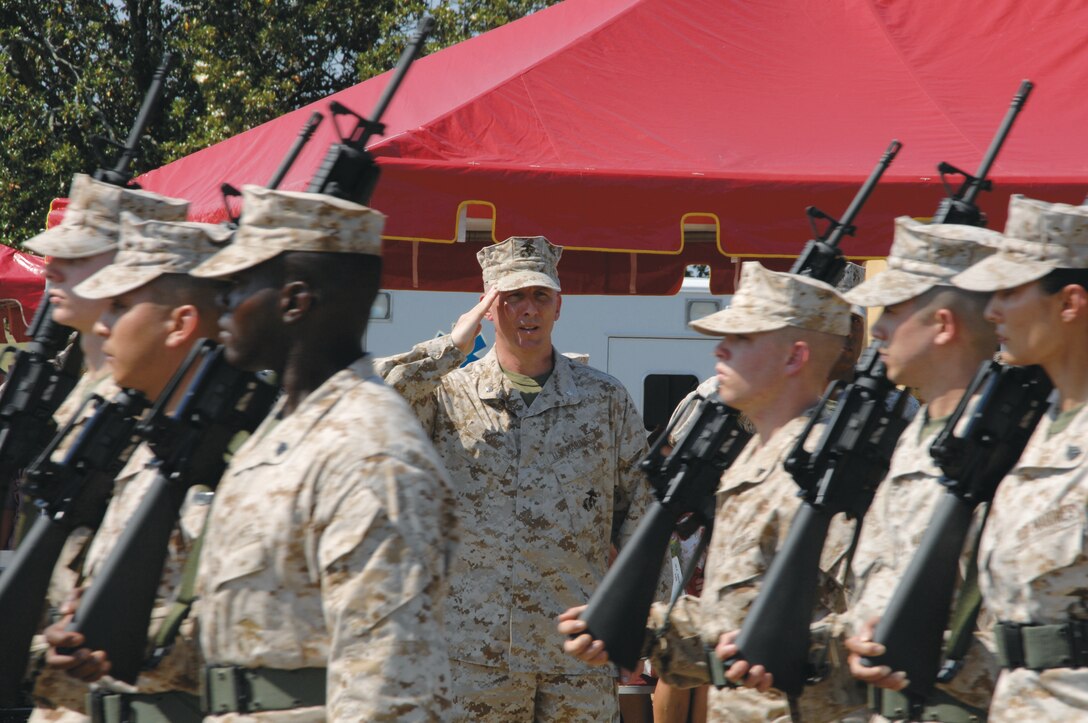 Col. (select) Donald J. Davis salutes Marines during a pass and review after becoming the newest commanding officer of Marine Corps Logistics Base Albany Friday. He replaced Col. Terry V. Williams.