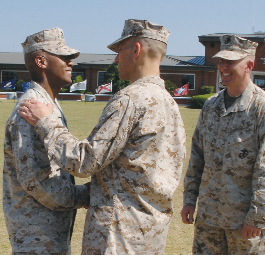 Brig. Gen. Thomas A. Gorry, commanding general, Marine Corps Installations East, Camp Lejeune, N.C., shakes hands with Col. Terry V. Williams, outgoing commanding officer, Marine Corps Logistics Base Albany, as Col. (select) Donald J. Davis, incoming CO, looks on.