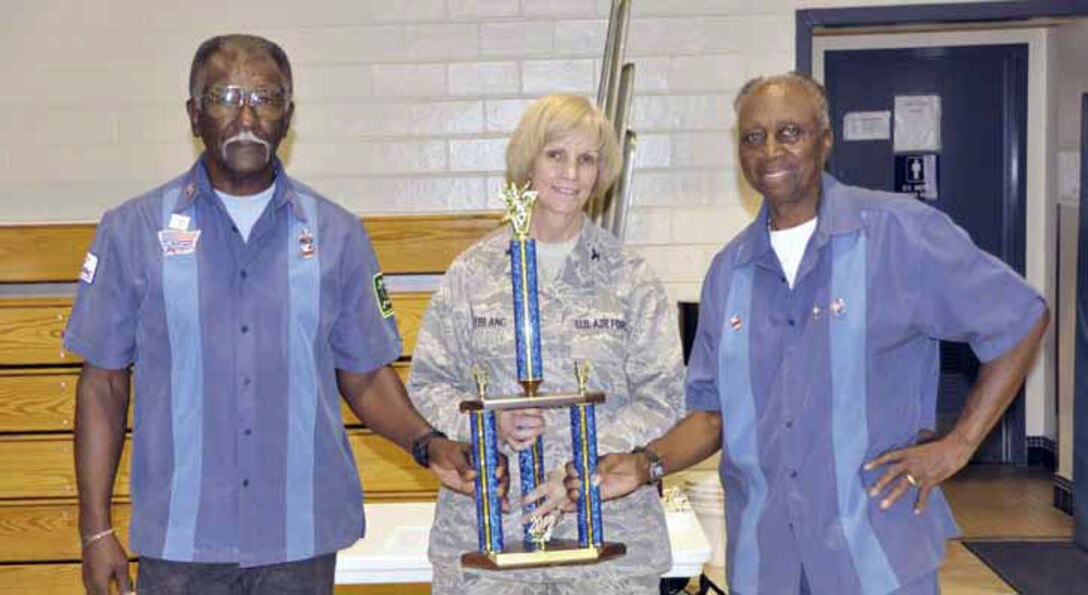 From left are Goodwin Ocab and Robert Slade. Members not shown are coach
Booker Woods and assistant coach Will June. Col Pam LeBlanc, 452 MSG commander, center, presents the trophy. (U.S. Air Force photo)
