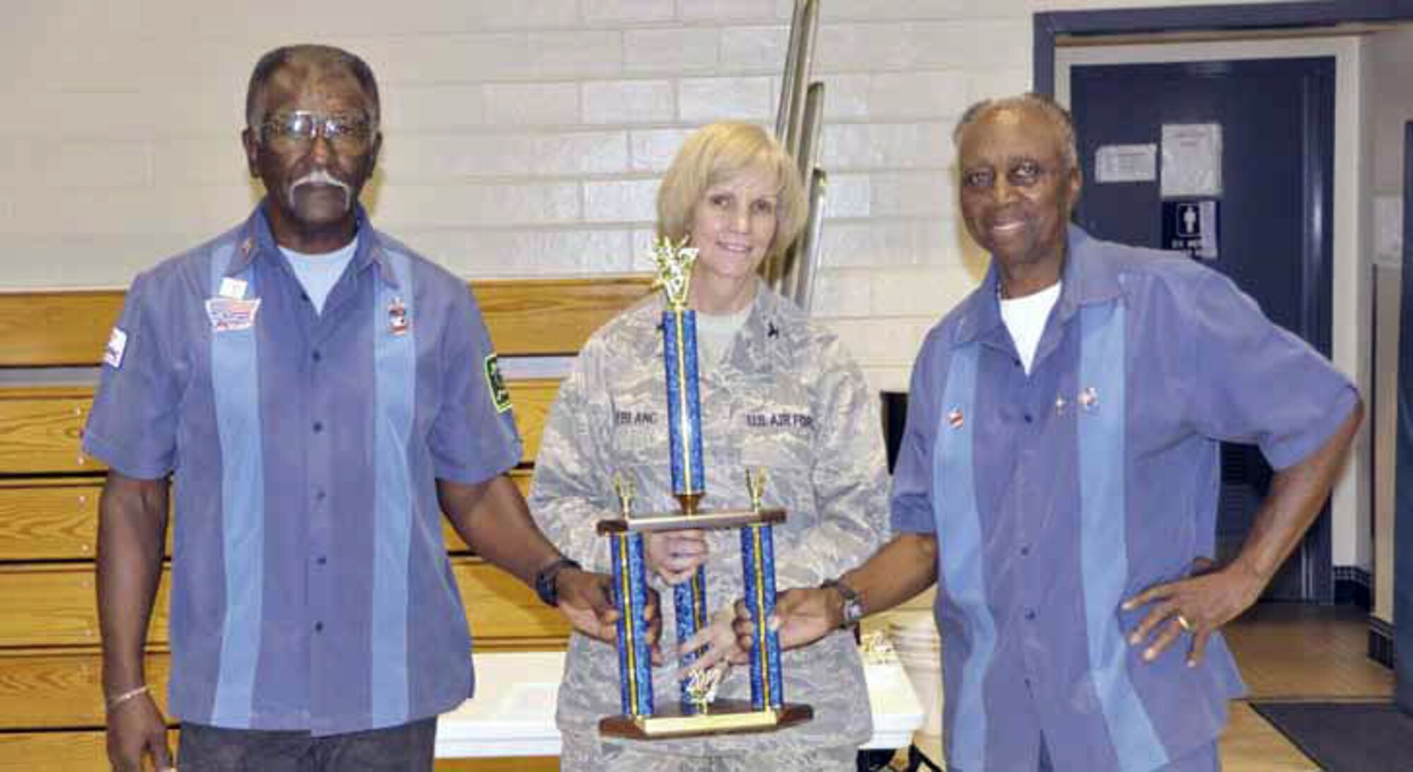 From left are Goodwin Ocab and Robert Slade. Members not shown are coach
Booker Woods and assistant coach Will June. Col Pam LeBlanc, 452 MSG commander, center, presents the trophy. (U.S. Air Force photo)