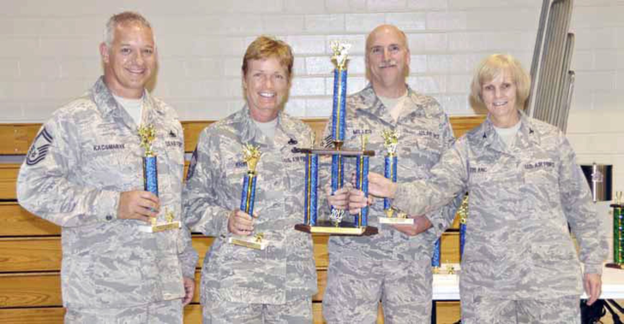 Team members from left are Senior Master Sgt. Michael Kacsmaryk, assistant
coach, Chief Master Sgt. Karen Krause and Tech. Sgt. Richard Miller. Members
not shown are coach Aaron Wall, Kathleen Buckner, and Tom Maupin. Col Pam LeBlanc, 452 MSG commander, right, presents the trophy. (U.S. Air Force photo)