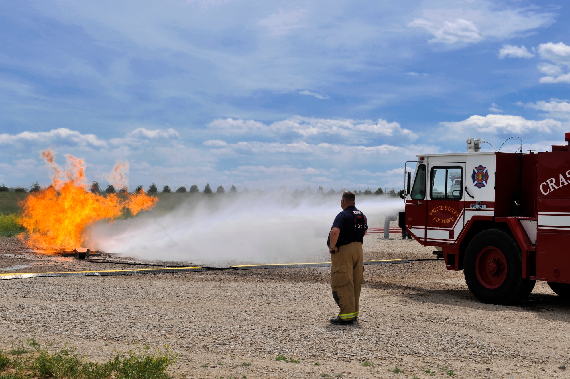 BUCKLEY AIR FORCE BASE, Colo. – Buckley Fire Department’s  rescue vehicle sprays water onto a fire during a training exercise May 30, 2012. Emergency response vehicles were used in the live-fire training for simulated fuel spills. (U.S. Air Force photo by Airman 1st Class Riley Johnson) 