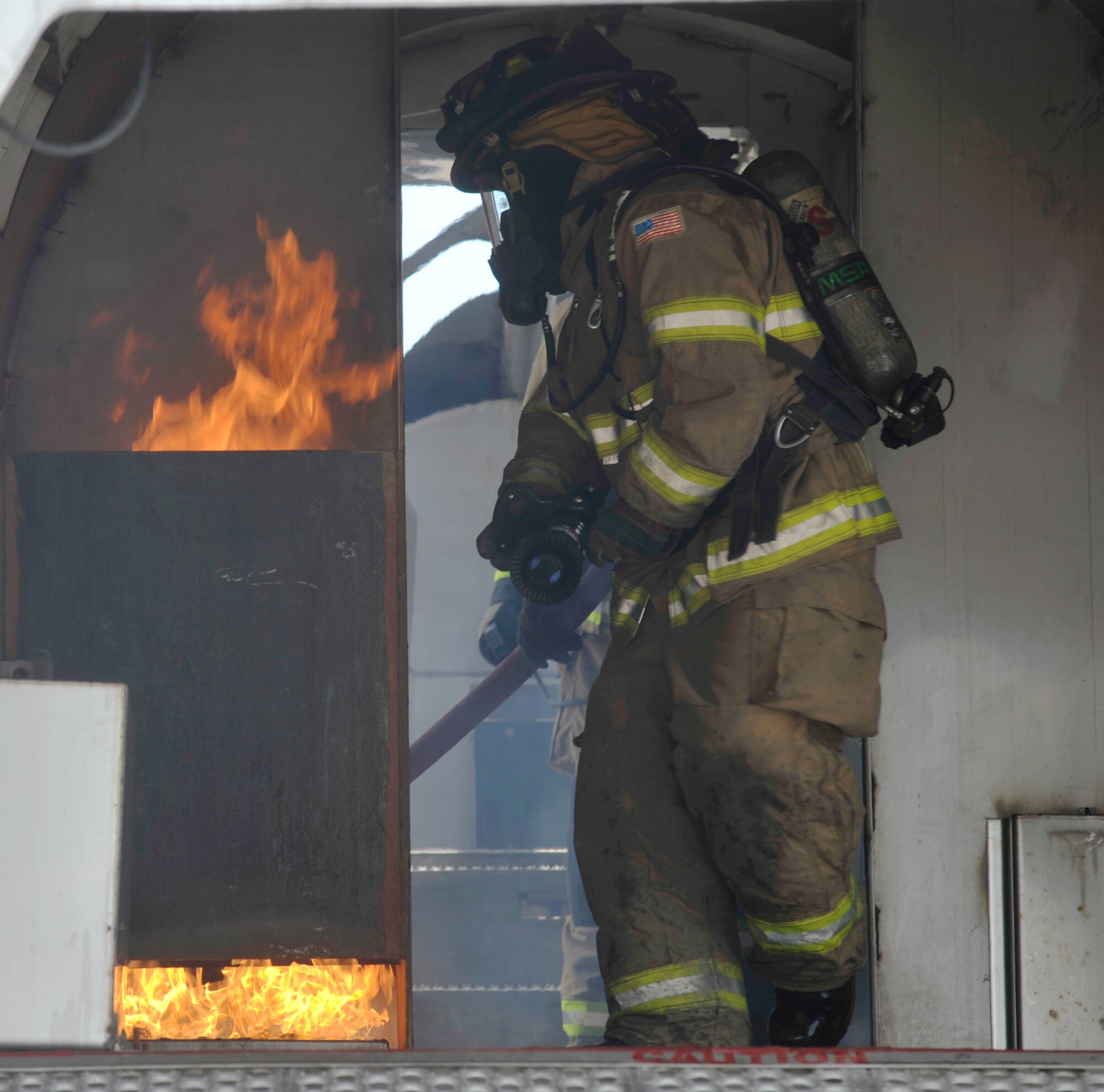 BUCKLEY AIR FORCE BASE, Colo. – Buckley firefighters along with members of Sable Altura Fire Department extinguish a fire inside of a mobile air fire trainer, May 30, 2012.  The training was hosted by the Buckley Fire Department. (U.S. Air Force photo by Airman 1st Class Riley Johnson) 