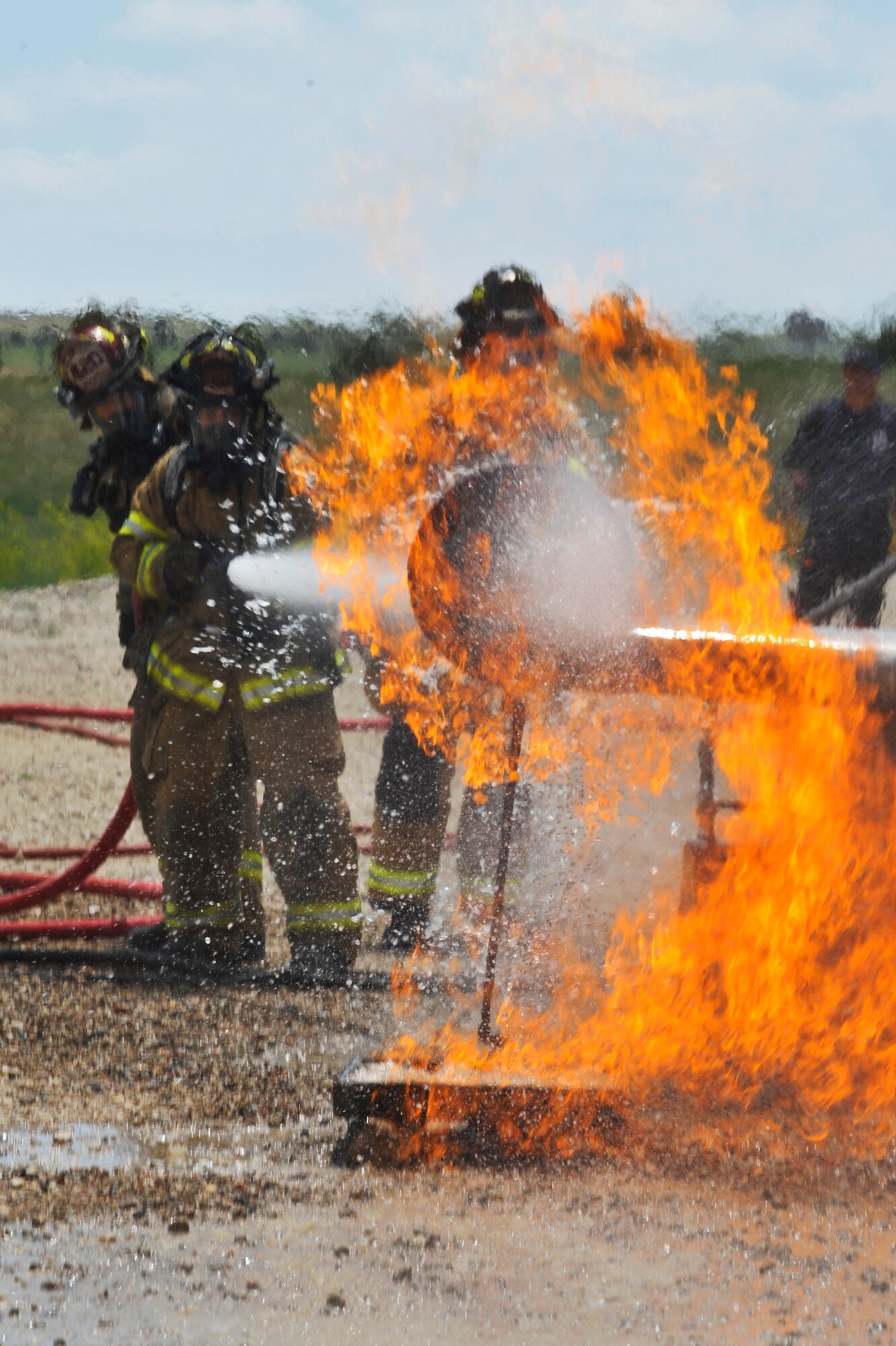 BUCKLEY AIR FORCE BASE, Colo. – Members of the Sable Altura Fire Rescue joined Buckley firefighters in airplane-live-fire training May 30, 2012. It’s a Federal Aviation Administration requirement for civilian fire departments to be certified on aircraft rescue fire fighting annually. (U.S. Air Force photo by Airman 1st Class Riley Johnson) 
