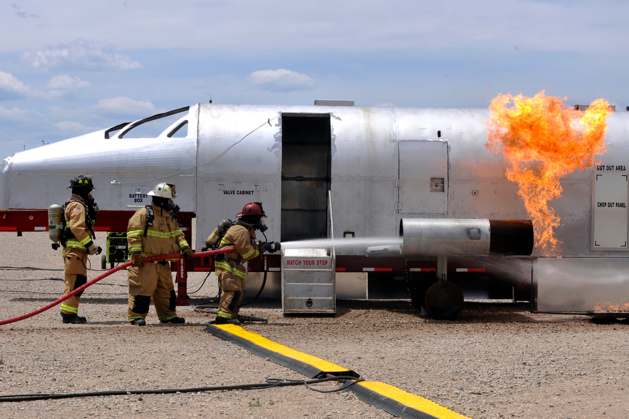 BUCKLEY AIR FORCE BASE, Colo. – Buckley firefighters perform live-fire training on a mobile air fire trainer here May 30, 2012. The new MAFT unit will be used by Buckley, F.E. Warren AFB and local civilian fire departments to meet live-fire training requirements. (U.S. Air Force photo by Airman 1st Class Riley Johnson)
