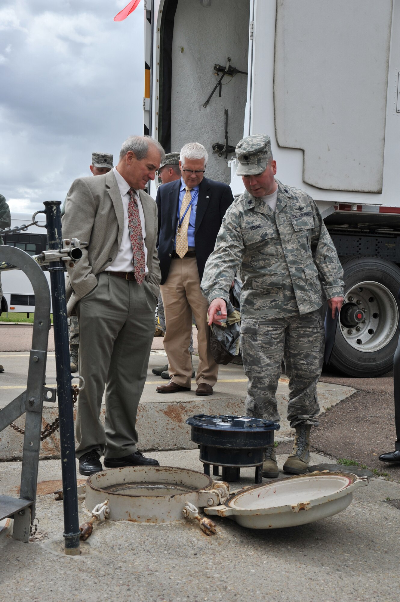 Lt. Col. Brian Young, 341st Maintenance Operations Squadron commander, explains to Callicutt the procedures technicians have to follow to gain access to a launch facility while pointing to an environmental cover. James Colasacco, Chief of Global Strike Capabilities Division for USSTRATCOM, looks on, May 24. The two were at Malmstrom for an orientation tour of the 341st Missile Wing May 22 to 24. (U.S. Air Force photo/John Turner)