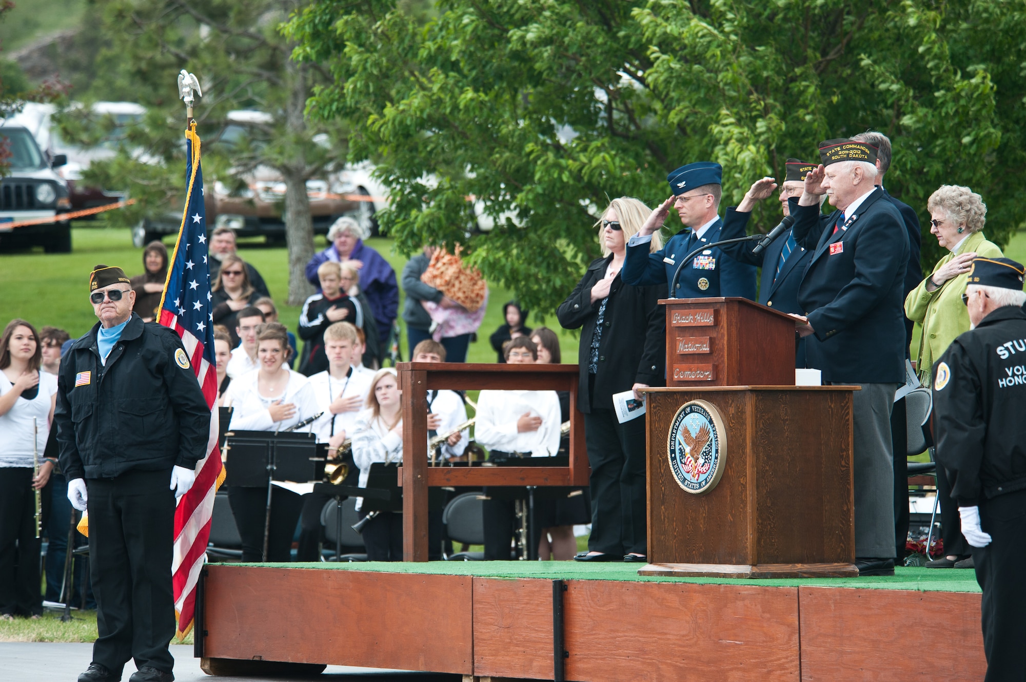 Attendees of the Memorial Day Program salute the Sturgis Volunteer Honor Guard during posting of the colors at the Black Hills National Cemetery, S.D., May 28, 2012. Black Hills National Cemetery held two ceremonies paying homage to all those who answered the nations call, and made the ultimate sacrifice in defense of our Nation. (U.S. Air Force photo by Airman 1st Class Alystria Maurer/Released)
