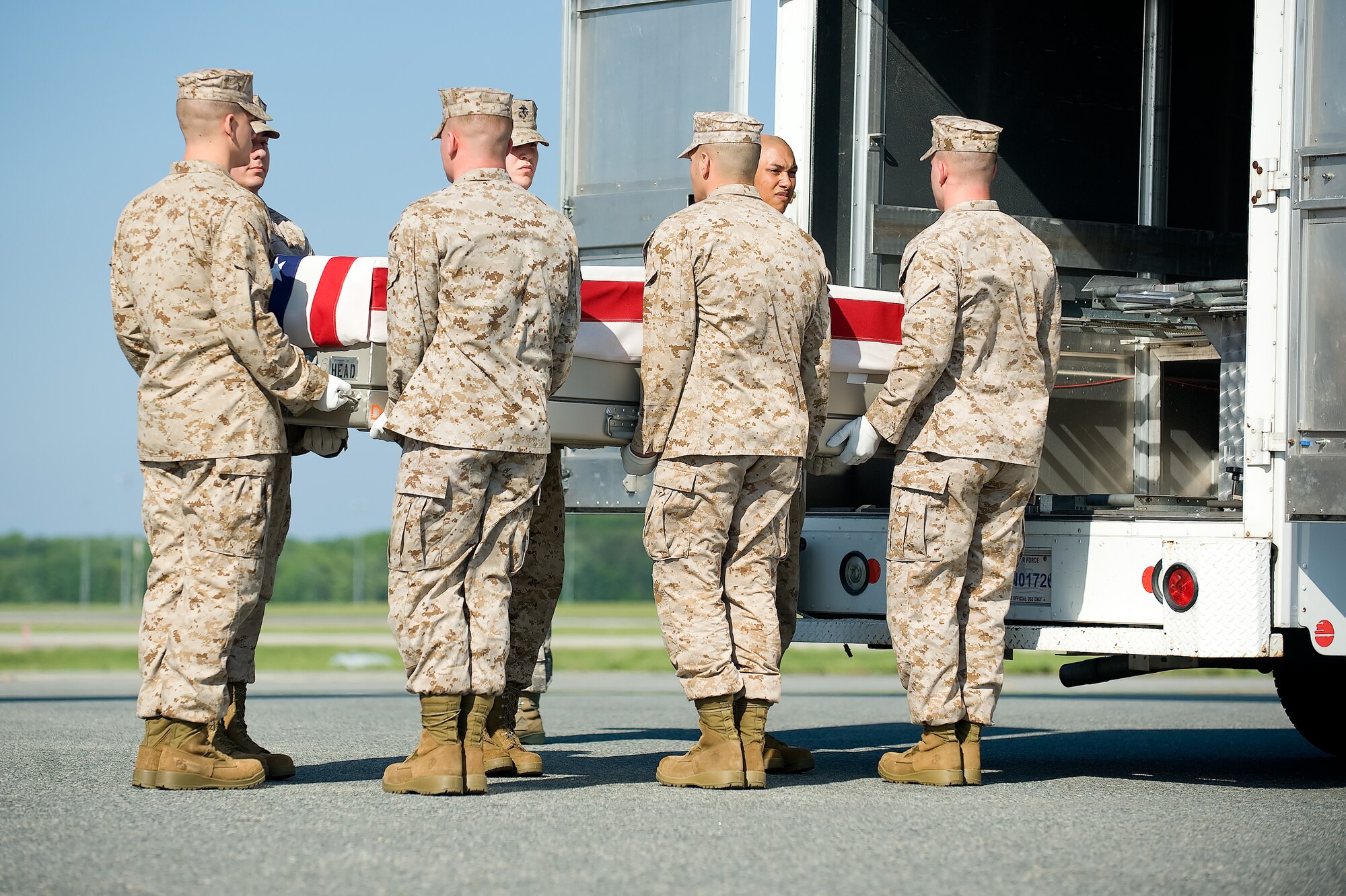 A U.S. Marine Corps carry team transfers the remains of Marine Sgt. Julian C. Chase of Edgewater, Md., at Dover Air Force Base, Del., May 29, 2012. Chase was assigned to 5th Naval Gunfire Liaison Company, III Marine Expeditionary Force, Okinawa, Japan. (U.S. Air Force photo/Adrian R. Rowan)
