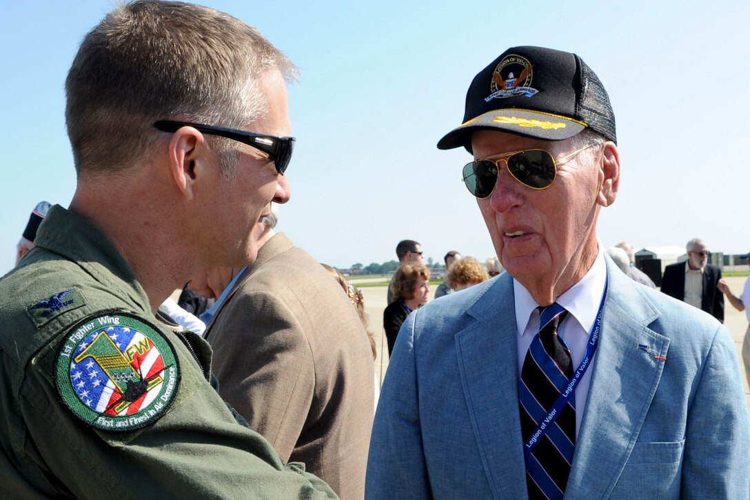 U.S. Air Force Col. Kevin Robbins, 1st Fighter Wing commander, talks with Distinguished Service Cross recipient James K. Kunkle on the flight line of Langley Air Force Base, Va., prior to the start of an F-22 Raptor demo, during a Legion of Valor tour, May 31, 2012. Kunkle, a combat pilot with the 1st FW during World War II, flew P-38 and P-57 aircraft. Kunkle received his medal for engaging 20 German aircraft, and downing two of them. (U.S. Air Force photo by Senior Airman Wesley Farnsworth/Released)