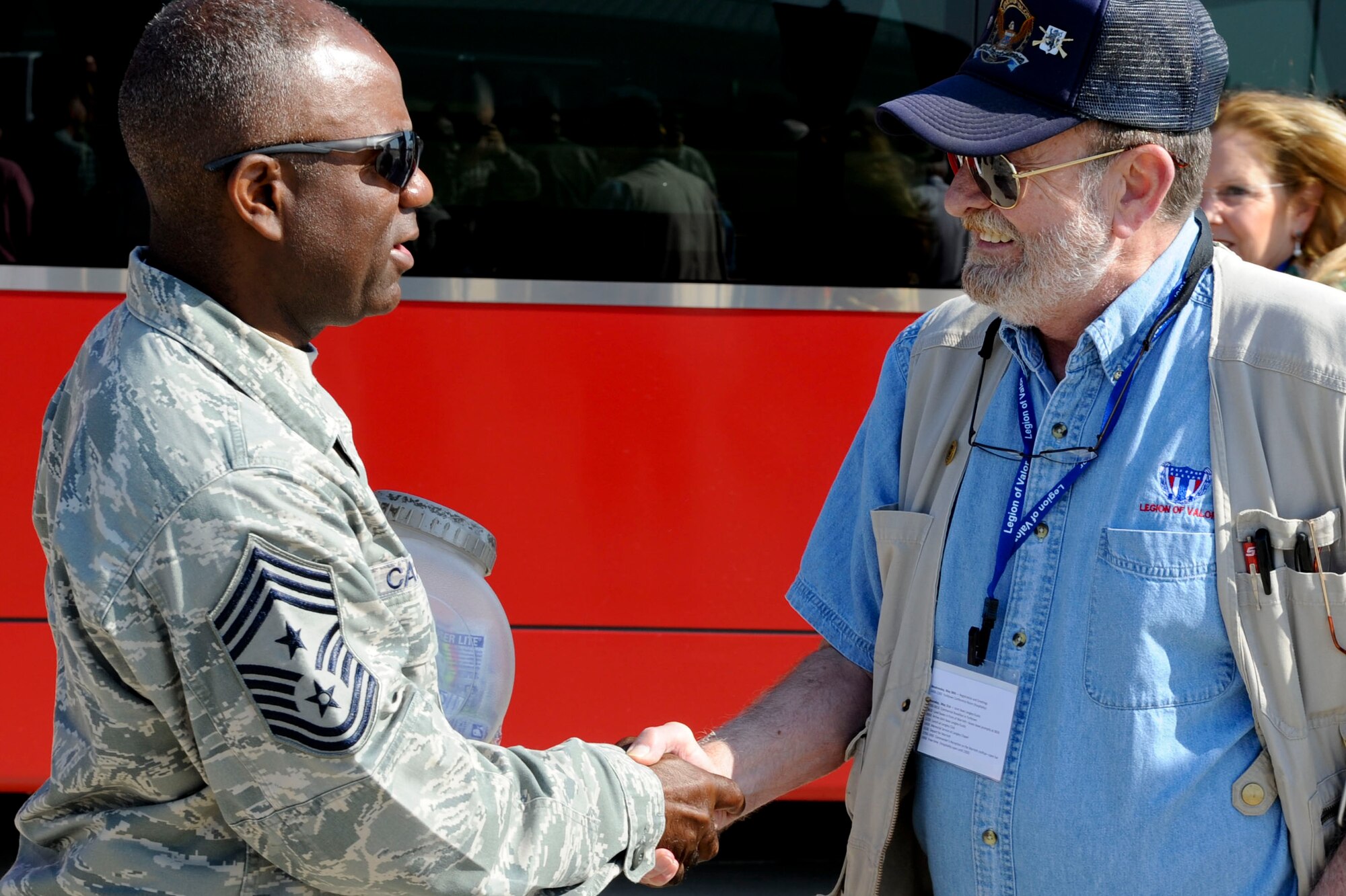 U.S. Air Force Chief Master Sgt. Gary Carter, 1st Fighter Wing command chief, greets Distinguished Service Cross recipient James Kirk on the flight line of Langley Air Force Base, Va., during a Legion of Valor tour, May 31, 2012. During the tour members watched an F-22 Raptor demo, toured the aircraft and participated in a memorial service honoring the members who passed away since their last meeting. (U.S. Air Force photo by Senior Airman Wesley Farnsworth/Released)