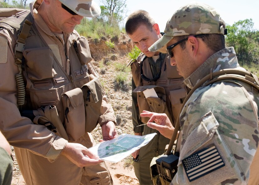 Dyess airmen orient a map to determine their location during navigation and personnel recovery training May 16, 2012, at Lake Abilene in Abilene, Texas. During the navigation and personnel recovery training, airmen have to navigate difficult terrain to a rally point while avoiding capture. (U.S. Air Force photo by Airman 1st Class Peter Thompson/ Released)