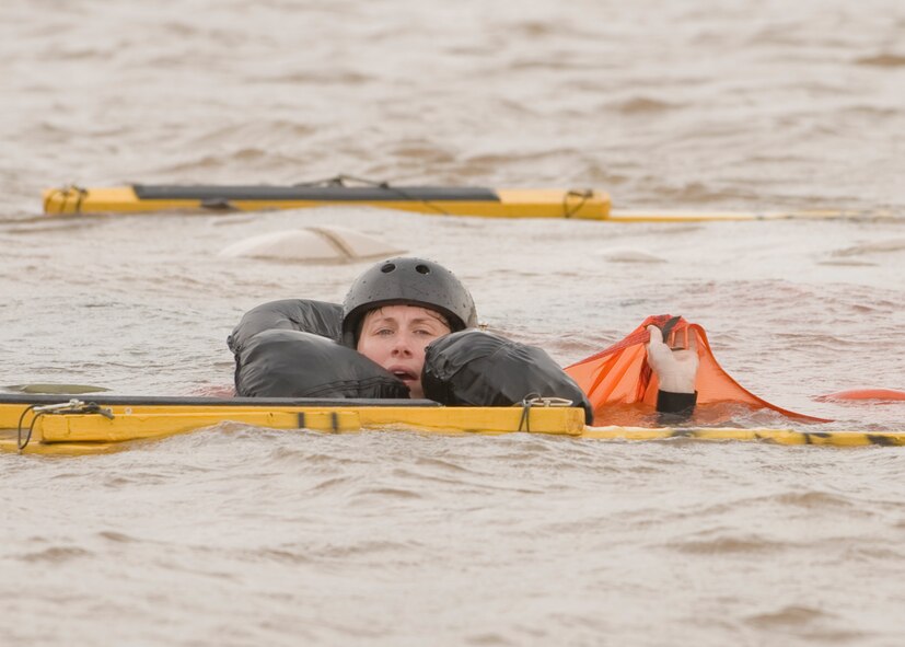 U.S. Air Force Capt. Alicia Datzman, 28th Bomb Squadron, untangles herself from a water-logged parachute during water survival training May 9, 2012, at Lake Fort Phantom in Abilene, Texas. The water survival course refreshes airmen on events that might occur during an aircraft water landing. (U.S. Air Force photo by Airman 1st Class Peter Thompson/ Released)