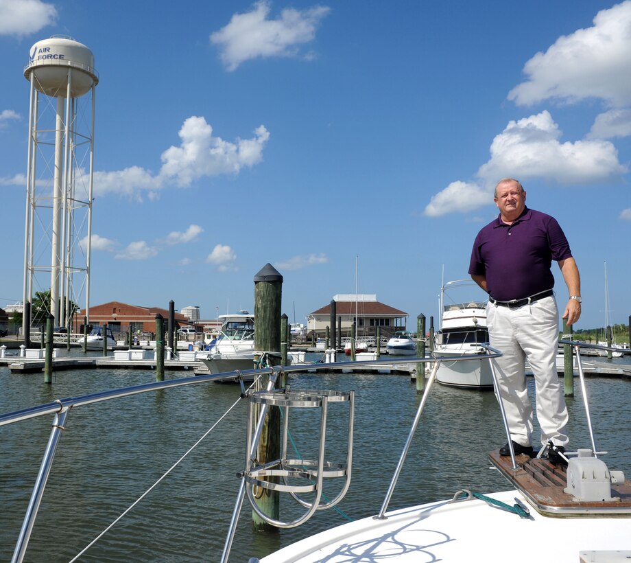 Richard Watson, a Navy Special Emphasis Operations Atlantic team leader with the Defense Contract Management Agency, stands on the bow of his boat at the Langley Marina, Langley Air Force Base, Va., May 29, 2012. Watson chose to live on his boat to gain experience on the water because he hopes to retire in a house boat on the Tennessee River. (U.S. Air Force photo by Airman 1st Class Austin Harvill/Released)