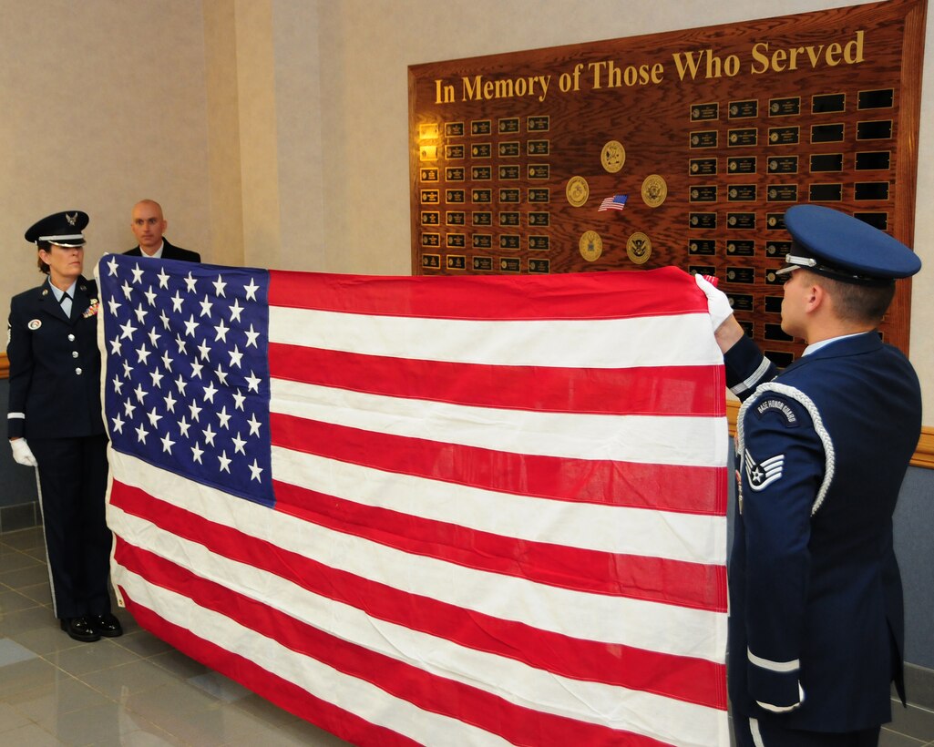 Members of the Niagara Falls Air Reserve Station Base Honor Guard perform a flag folding ceremony at the Buffalo Military Entrance Processing Station at Niagara Falls Air Reserve Station, N.Y. on 31 May 2012. Looking on is Lieutenant Commander Keith Archibald, Commander of the Buffalo Military Entrance Processing Station. The honor guard was on hand during a memorial service for local fallen service members. Invited guests included; U.S. Army Colonel Todd Garlick, Commander of Eastern Sector U.S. Military Entrance Processing Command, and members of local veterans groups. (U.S. Air Force photo by Peter Borys)