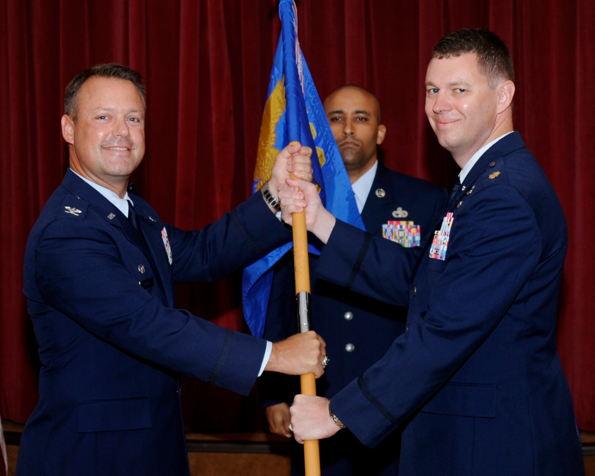 Col. James Hodges, 6th Mission Support Group commander, passes the guidon to Lt. Col. Collin Gilbert, 6th Logistics Readiness Squadron commander, during the Assumption of Command Ceremony at MacDill Air Force Base, Fla., May 31, 2012.  (U.S. Air Force photo by Airman 1st Class Melanie Bulow-Kelly/Released)     

