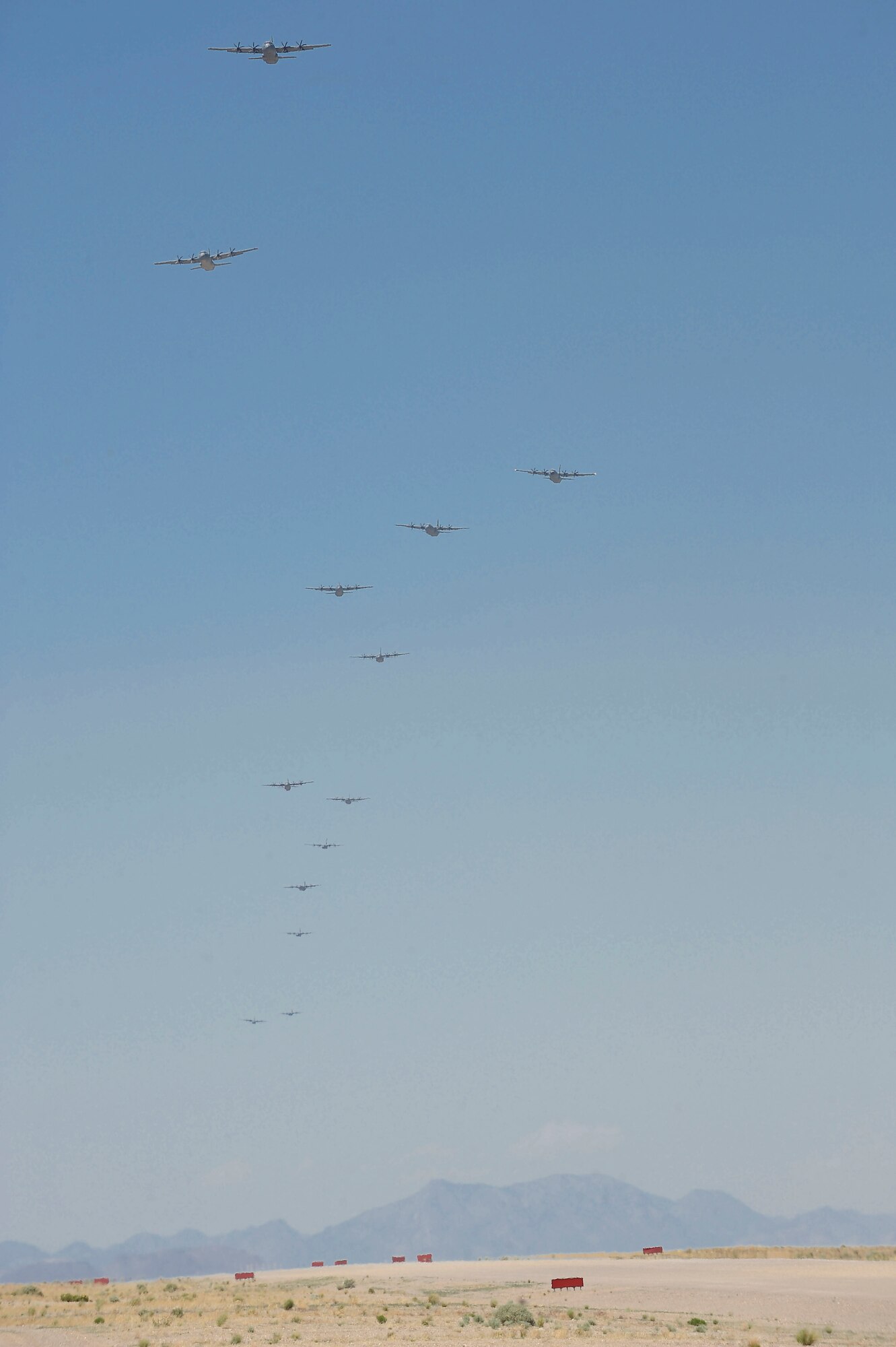 C-130s fly over the Nevada Test Training Range during Mobility Forces Exercise 12A in Tonopah, Nev., May 23, 2012. The exercise is part of the six-month Weapons Instructor Course held at the Weapons School located at Nellis Air Force Base, Nev. (U.S. Air Force photo by Staff Sgt. Ciara Wymbs/Released) 