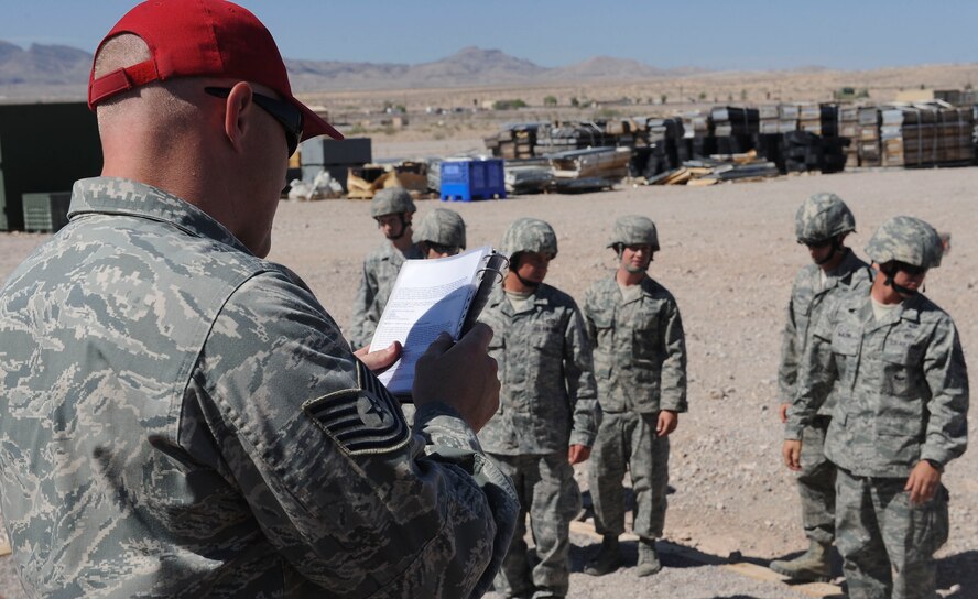 U.S. Air Force Tech. Sgt. Mitchell Romag, 820th RED HORSE Squadron, reads a pre-jump briefing to Airmen and Soldiers in preparation for Mobility Forces Exercise 12A at Nellis Air Force Base, Nev., May 22, 2012. MAFEX is a bi-annual, training scenario hosted by the U.S. Air Force Weapons School to prepare Airmen and Soldiers for joint deployments. (U.S. Air Force photo by Staff Sgt. Ciara Wymbs/Released)  