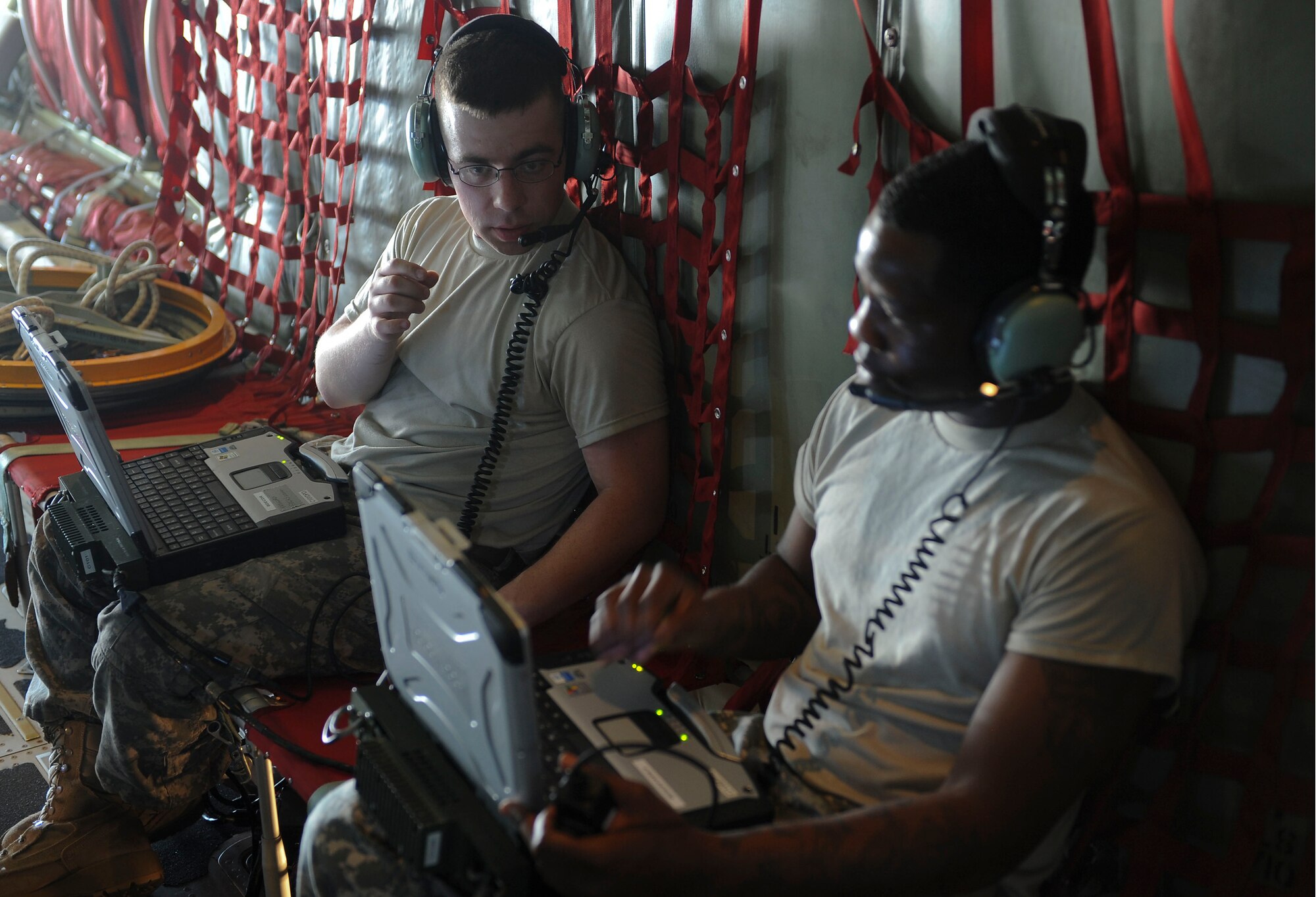 U.S. Army Sgt. John Koll and Spc. Lawrence Monroe, Charlie Company, HHB, XVIII Airborne Corps secure enroute communications specialists, check lines of communications for Mobility Forces Exercise 12A at Nellis Air Force Base, Nev., May 22, 2012.  Soldiers and Airmen teamed up during the exercise to prepare for joint deployments. (U.S. Air Force photo by Staff Sgt. Ciara Wymbs/Released)