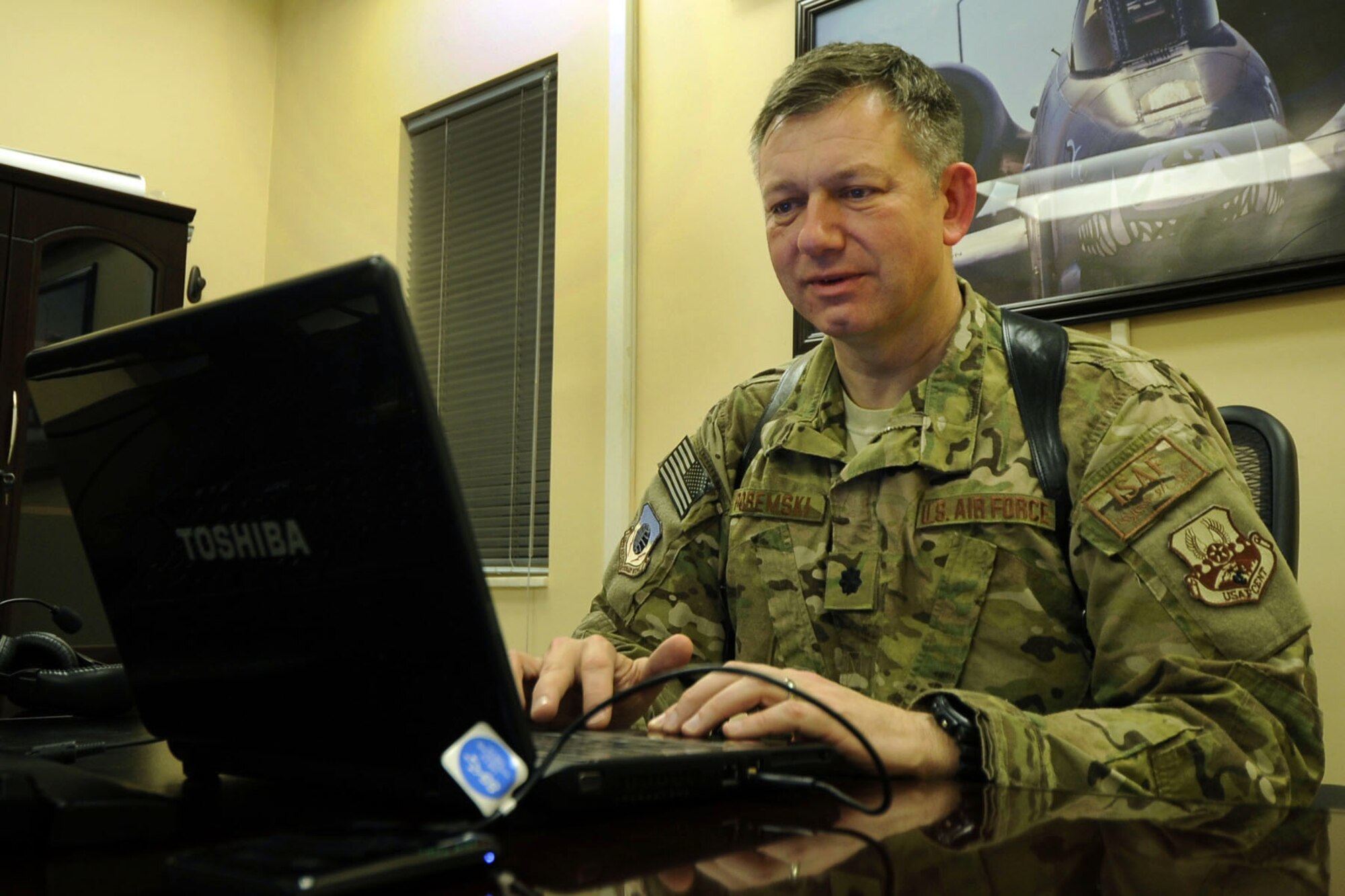 Lt. Col. Bob Poremski, 455th Air Expeditionary Wing deputy chief of Wing Plans and Programs logs on to Skype using the 455 AEW Vulture Net morale wireless network to watch a webcast of his son's high school graduation in California while serving at Bagram Airfield, Afghanistan, May 25, 2012. The network, a service provided by the 455th Expeditionary Communications Squadron, enables deployed Airmen to stay connected to friends and family back home while they support military operations here. (U.S. Air Force photo/Capt. Raymond Geoffroy)
