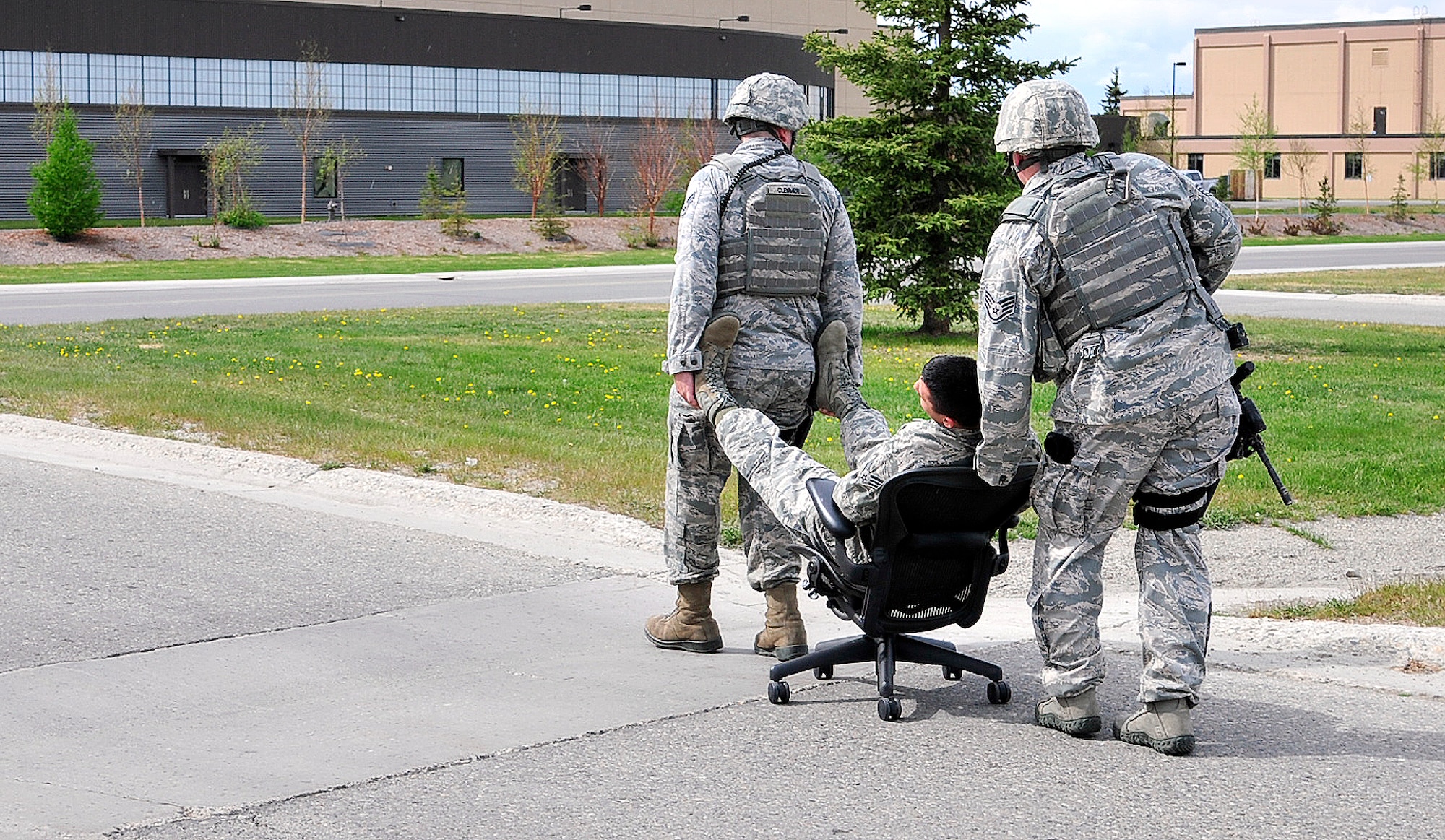 U.S. Air Force Airmen with the 354th Security Force Squadron use a makeshift wheelchair to escort an injured Airman during an active shooter exercise May 23, 2012, Eielson Air Force Base, Alaska. Airmen were tested on their capability to respond to a duress situation in the event that a threat arises. (U.S. Air Force photo/Airman 1st Class Zachary Perras)