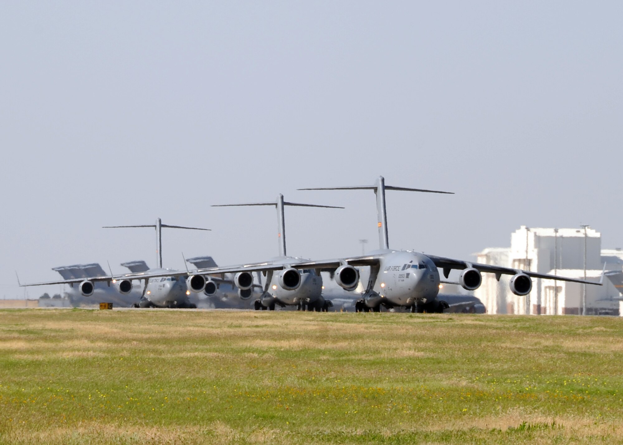 ALTUS AIR FORCE BASE, Okla. – Three C-17 Globemaster III’s from the 58th Airlift Squadron, taxi on the runway before departing for the Mobility Air Force Exercise at Nellis AFB, Nev., May 23, 2012. More than 60 tanker and airlift aircraft from across the country along with more than 25 fighter aircraft participated in the MAFEX, which is sponsored by the U.S. Air Force Weapons School at Nellis, AFB. (U.S. Air Force photo by Airman 1st Class Franklin R. Ramos / 97th Air Mobility Wing / Released)