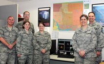 From left to right: Master Sgt. Joshua Buck, Tech. Sgt. Thomas Doerner, Staff Sgt. Robin Lewis, Staff Sgt. Renee Dunn, Tech. Sgt. Denette Tennell, and Chief Master Sgt. Kevin Jurgella. The 5th Bomb Wing Weather Flight is the sole weather agency on Minot Air Force Base. The flight is responsible for providing both the 91st Missile Wing and 5th Bomb Wing with meteorological services for all aspects of operations.  This includes supporting aircrews in the B-52H Stratofortress and UH-1 platforms, providing surface weather observations for airfield operations, and weather warnings for the Minot AFB community and the 91st Missile Wing Complex. (Photo Submission/Staff Sgt. Carmen Washington)