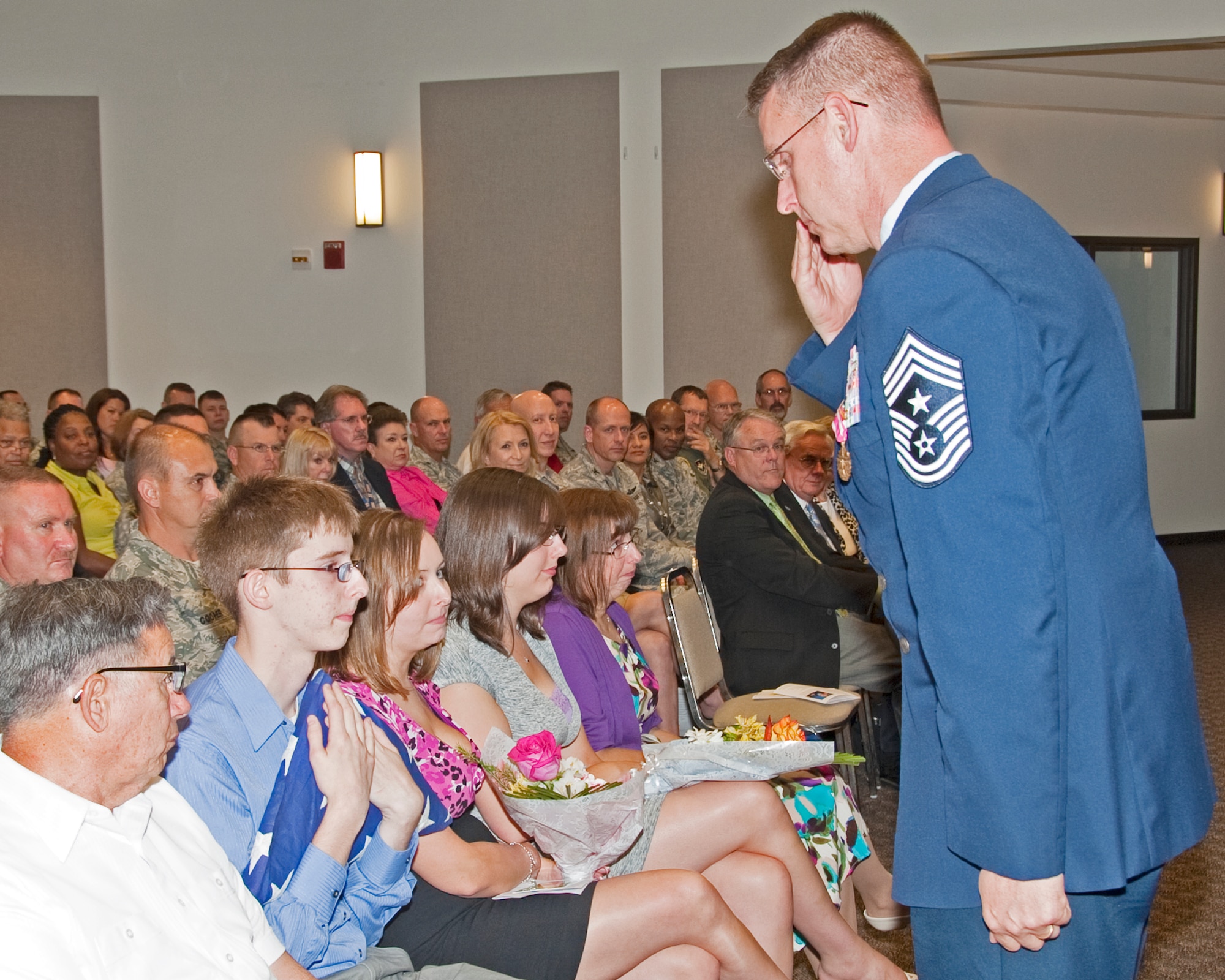 82nd Training Wing Command Chief Master Sgt. David Nelson salutes the flag presented to his family during his retirement ceremony May 30, 2012 at Sheppard Air Force Base.  Nelson officially retires 1 Sep 2012 after 30 years of service in the Air Force. (U.S. Air Force photo/Frank Carter)